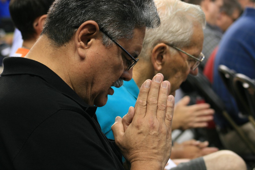 Alfonso G. Martinez Jr., a member of St. Patrick Parish in Fremont, Neb., prays the Our Father Aug. 4 at the Archdiocese of Omaha's third annual Heartland Catholic Men's Conference at D.J. Sokol Arena on the Creighton University campus in Omaha, Neb.