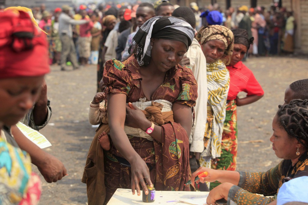 Civilians displaced by fighting wait for food rations at a camp near the eastern Congolese city of Goma.