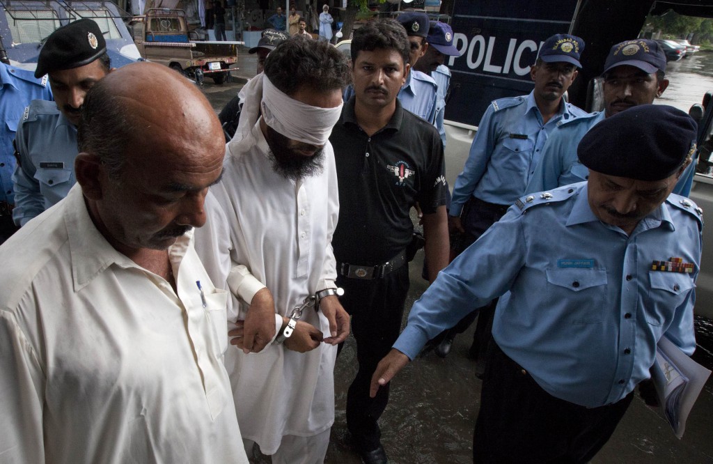 Police escort blindfolded Muslim cleric Khalid Jadoon Chishti as he is taken into court in Islamabad on September 2. Pakistani authorities arrested the imam on suspicion of framing Rimsha Masih, a Pakistani Christian girl accused of blasphemy.