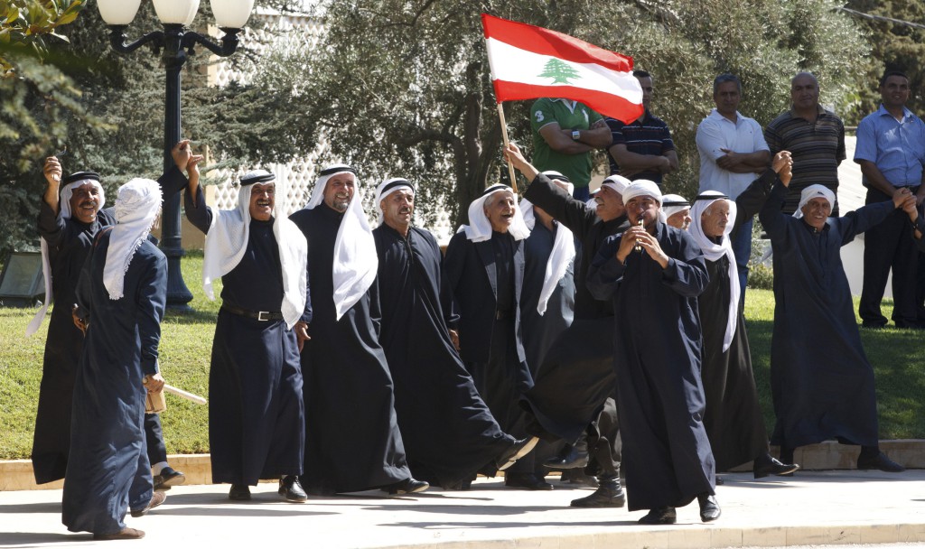 Men celebrate after Pope Benedict XVI arrives to the Baabda Presidential Palace for meetings on Sept. 15 with Lebanese leaders southeast of Beirut.