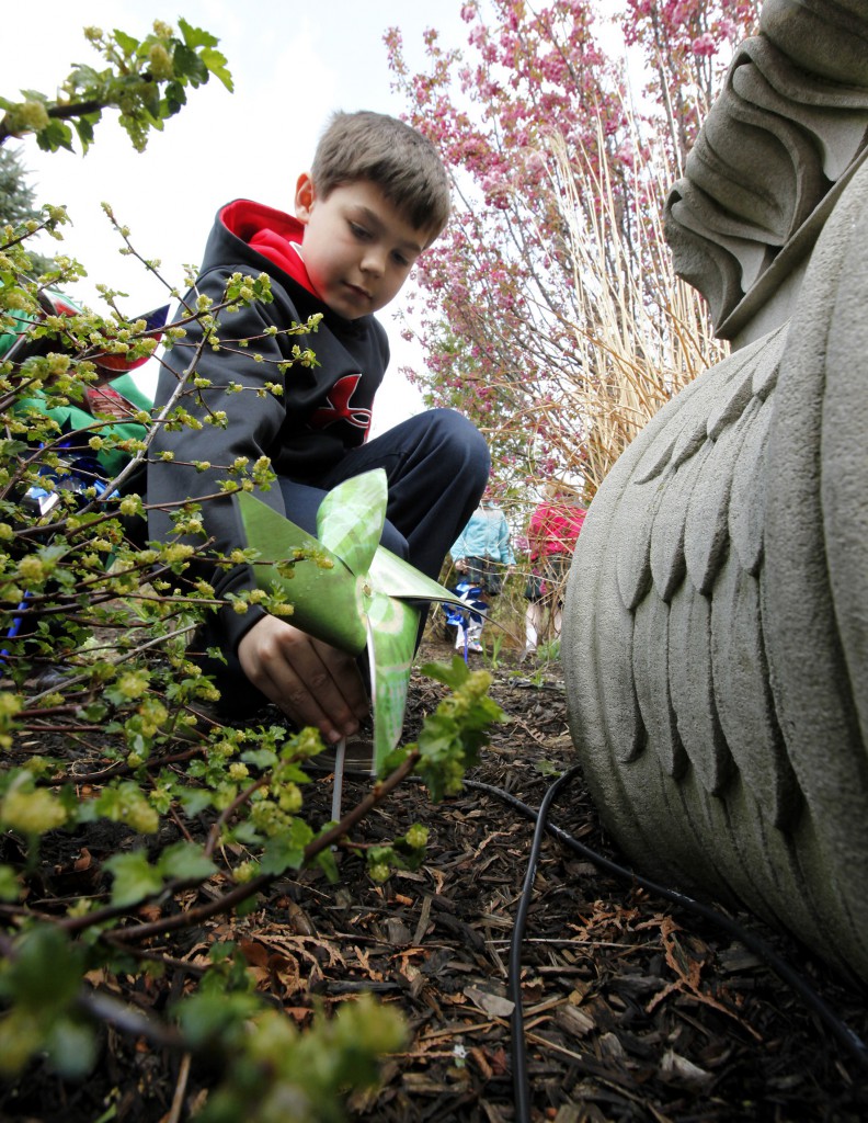 A student from St Mary of the Woods School in Chicago plants a pinwheel in the Archdiocese of Chicago’s Healing Garden on March 29 during an event to launch Child Abuse Prevention Month. The Healing Garden was dedicated last year as a place of respite for the survivors of sexual abuse, their families and others affected by abuse.
