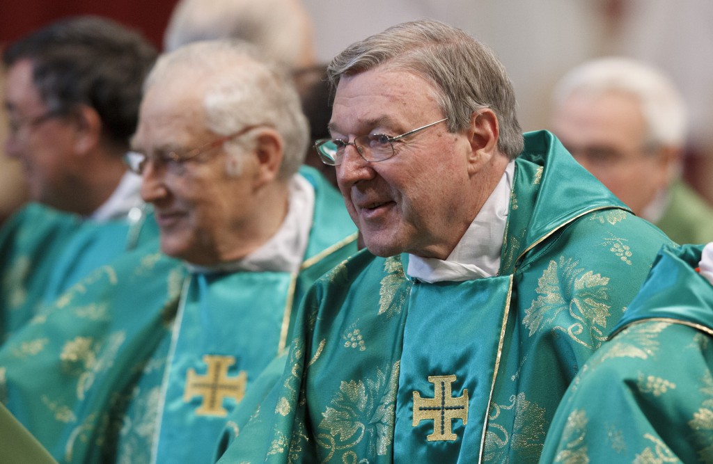 Cardinal George Pell of Sydney prepares to exchange the sign of peace during the closing Mass of the Synod of Bishops on the new evangelisation celebrated by Pope Benedict XVI in St. Peter's Basilica at the Vatican.