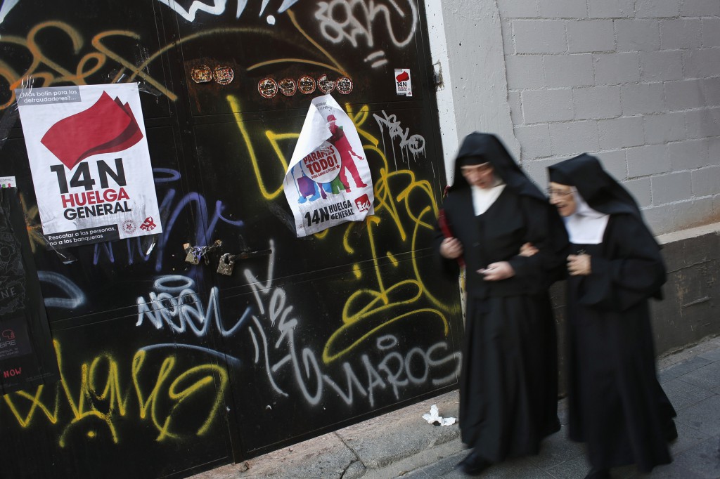 Two nuns walks past banners that read "14N, general strike" and "14N, We stop everything" in central Madrid Nov. 12. Spain's two largest labor unions called a general strike for Nov. 14, the second against the conservative government since it took power in December and coinciding with industrial action in Portugal on the same day.