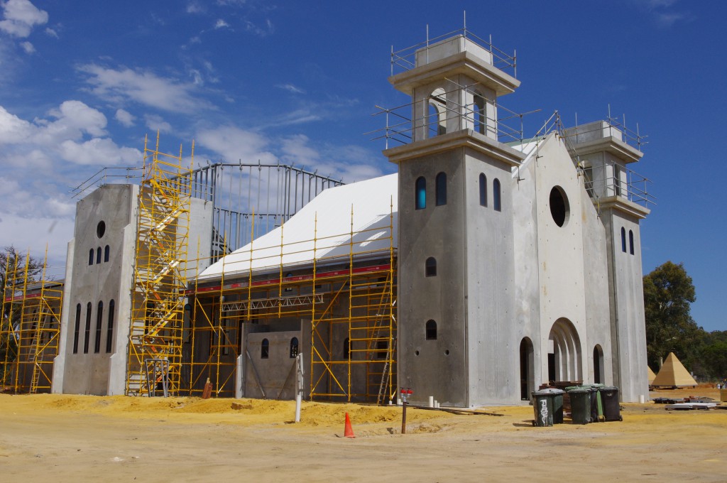The Romanesque-looking Divine Mercy Church at Maryville Downs near Lower Chittering takes shape and, below, an artist’s impression of the finished structure
