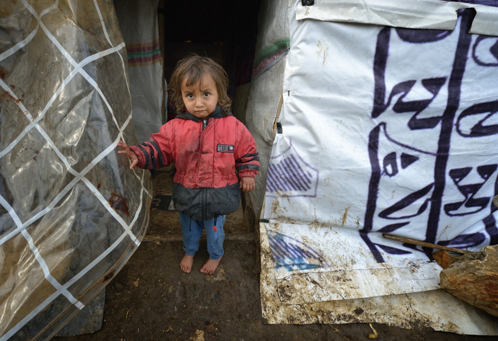 A refugee child from Syria stands outside a makeshift shelter in the village of Jeb Jennine, in Lebanon’s Bekaa Valley on November 22. No one is sure how many have already arrived.
