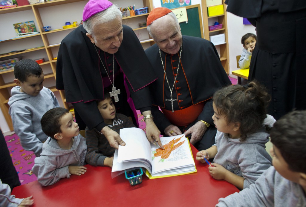US Cardinal Edwin O’Brien, right, and Auxiliary Bishop William Shomali of Jerusalem, visits with kindergarteners in Beit Sahour on November 28. 