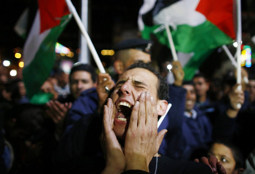 A Palestinian man reacts during a rally in the West Bank city of Ramallah on November 29 when the UN General Assembly approved a resolution to grant Palestine observer status, implicitly recognising a Palestinian state.