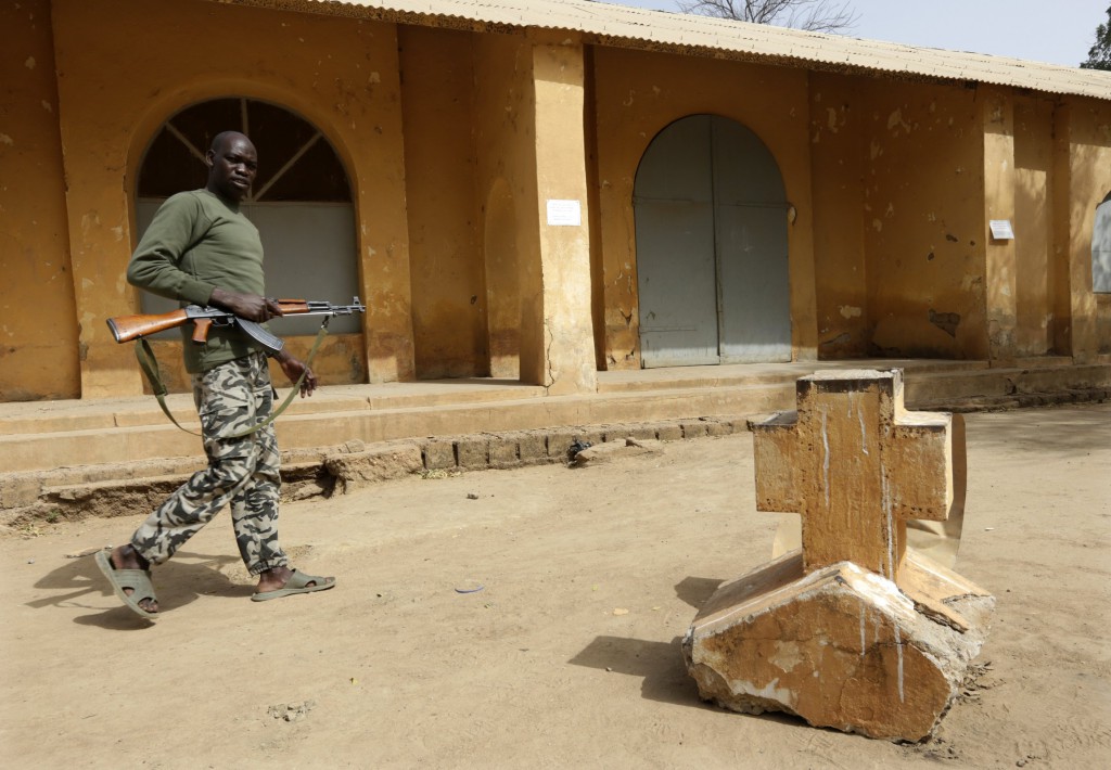 A Malian soldier walks past a cross from the church seen in the background in the recently liberated town of Diabaly on January 24. PHOTO: Erik Gaillard, Reuters