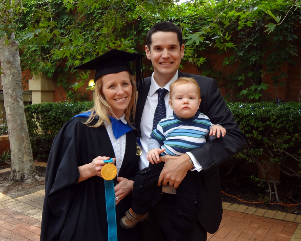 Rachel Dwyer holds her Olympic gold medal at her graduation with her husband and son. PHOTO: UNDA