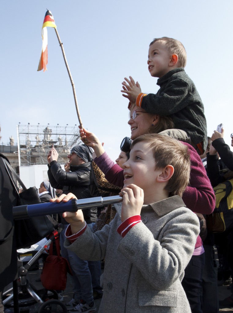 A boy watches the Pope with his telescope. PHOTO: CNS/Paul Haring