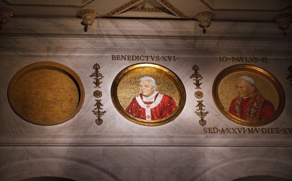 An empty slot indicates where a medallion of the future pope will be placed next to Pope Benedict XVI and his predecessor Blessed John Paul II in the Basilica of St. Paul Outside the Walls in Rome in this Sept. 2, 2011 file photo. The upper basilica walls contain medallions of all 265 popes. PHOTO: CNS/Paul Haring