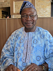 Michael Onaiyekan, whose brother is Cardinal John Olorunfemi Onaiyekan of Abjua, Nigeria, poses Feb. 24 at a restaurant in Tucson, Ariz., where he now lives. Onaiyekan talked with Catholic News Service about their childhood in a poor, farming family in Kabba, Nigeria. PHOTO: CNS/Patricia Zapor