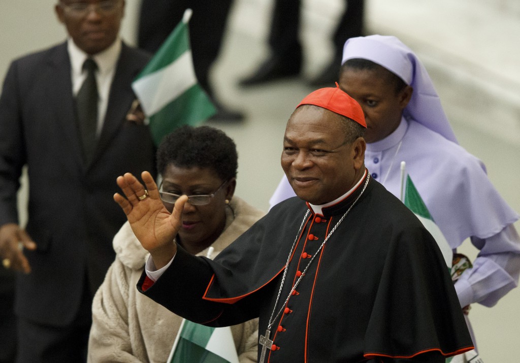 Cardinal John Olorunfemi Onaiyekan of Abuja, Nigeria, waves as he greets guests before Pope Benedict XVI's audience on Nov. 26 2012 in Paul VI hall at the Vatican. PHOTO: CNS/Paul Haring
