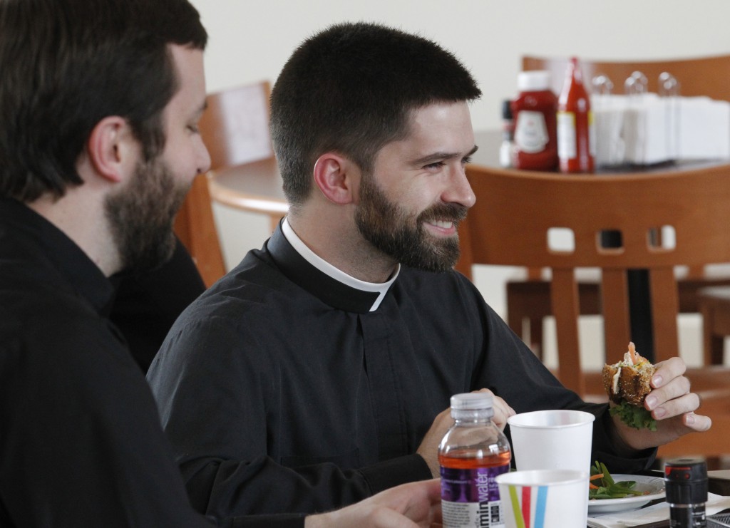 Deacon Dustin Dought, who is studying to be a priest for the Diocese of Lafayette, La., shares a light moment with other seminarians on Feb. 28 at Theological College in Washington. PHOTO: CNS/Bob Roller 