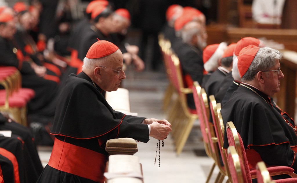 Cardinal Francis E. George of Chicago prays the rosary before a prayer service with eucharistic adoration in St. Peter's Basilica on March 6 at the Vatican. PHOTO: CNS/Paul Haring