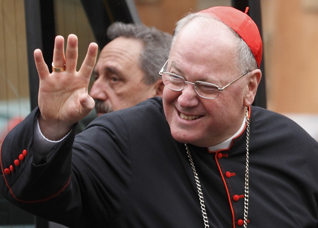 Cardinal Timothy M. Dolan of New York greets media as he arrives for the fourth day of general congregation meetings on March 7 in the synod hall at the Vatican. PHOTO: CNS/Paul Haring
