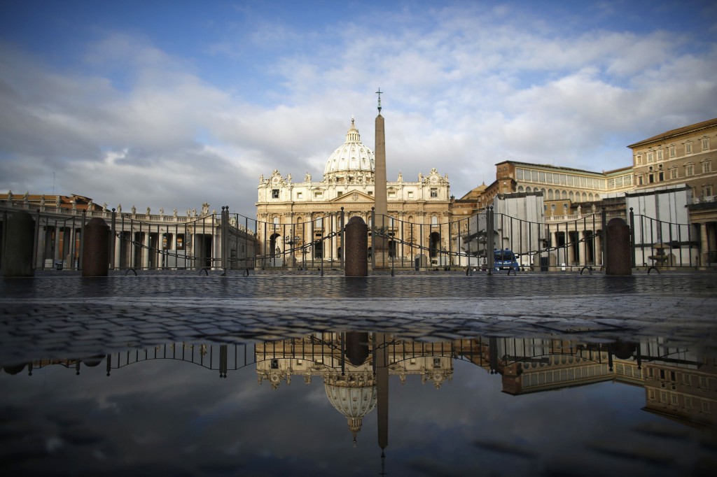 St. Peter's Basilica is reflected in a puddle near the Vatican on  March 11 as the world's cardinals will begin their conclave inside the Vatican's Sistine Chapel on March 12 to elect a new pope. PHOTO: CNS/Paul Hanna, Reuters