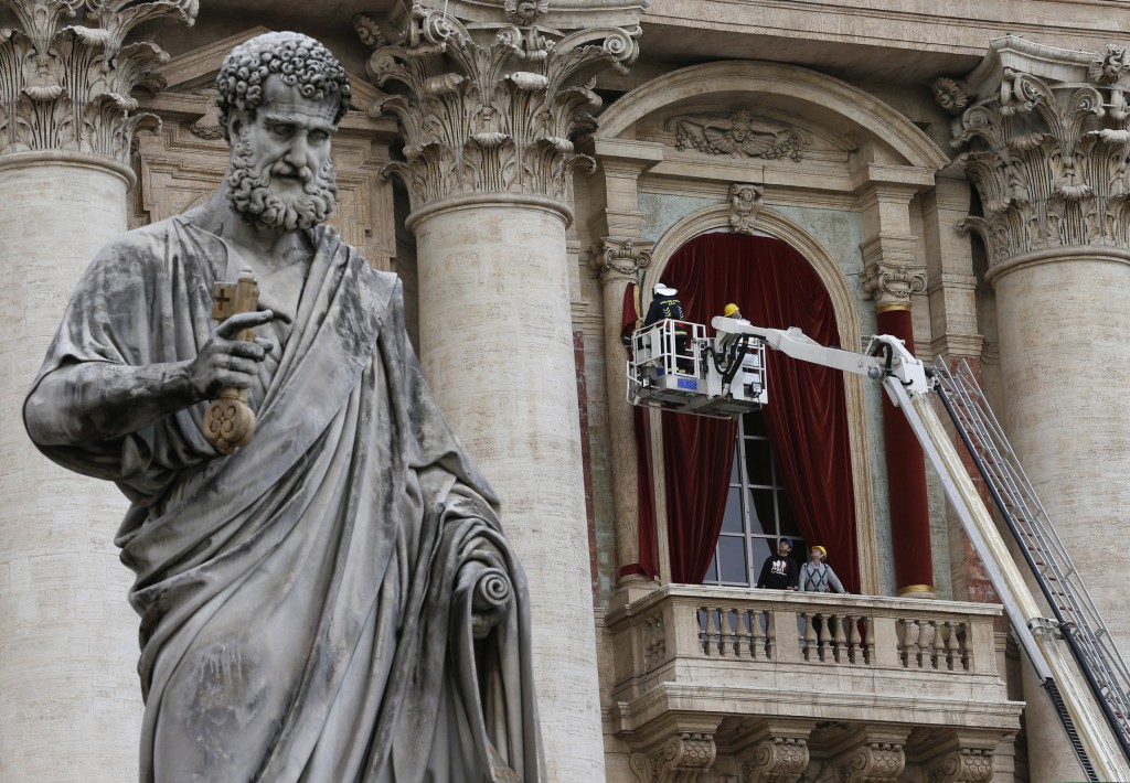 Workers prepare the central balcony of St. Peter's Basilica at the Vatican on March 11, where the newly elected pope will greet the world for the first time from the balcony. PHOTO: CNS/Paul Haring