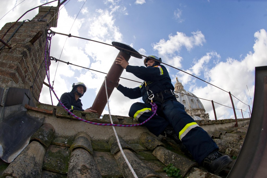 Members of the fire and rescue service set a chimney on the roof of the Sistine Chapel before the conclave on March 9 at the Vatican. Smoke coming from the chimney will be the only sign to the world of how things are progressing inside the chapel during the conclave. PHOTO: CNS/L'Osservatore Romano via Reuters