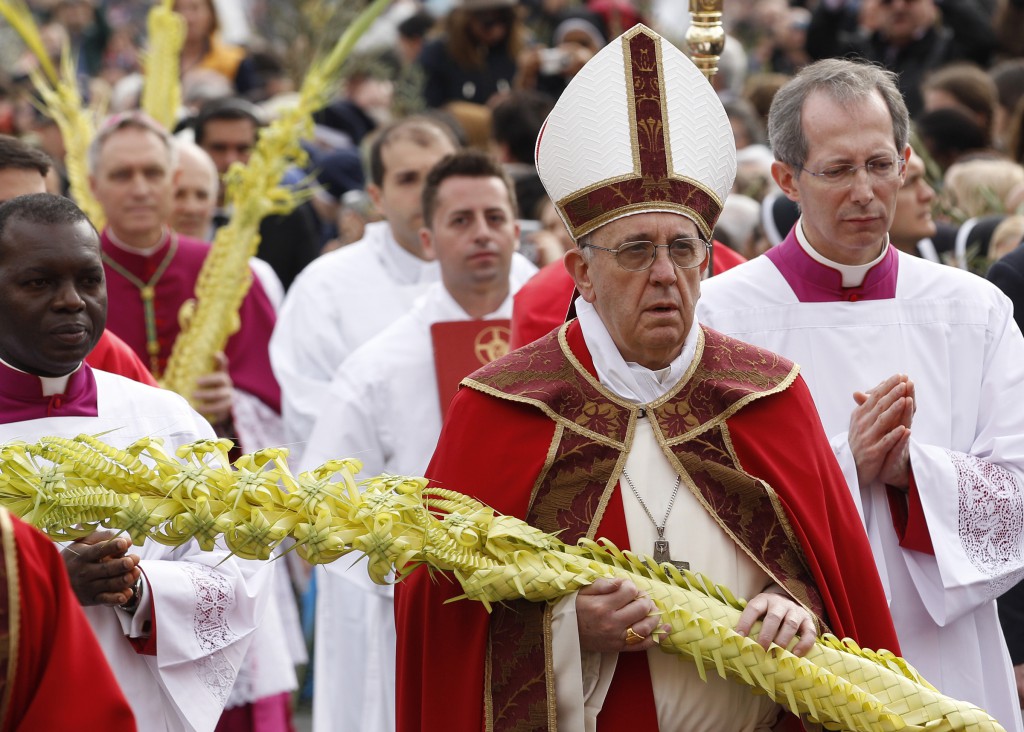 Pope Francis carries woven palm fronds as he walks in procession at the start of Palm Sunday Mass in St. Peter's Square on March 24 at the Vatican. PHOTO: CNS/Paul Haring