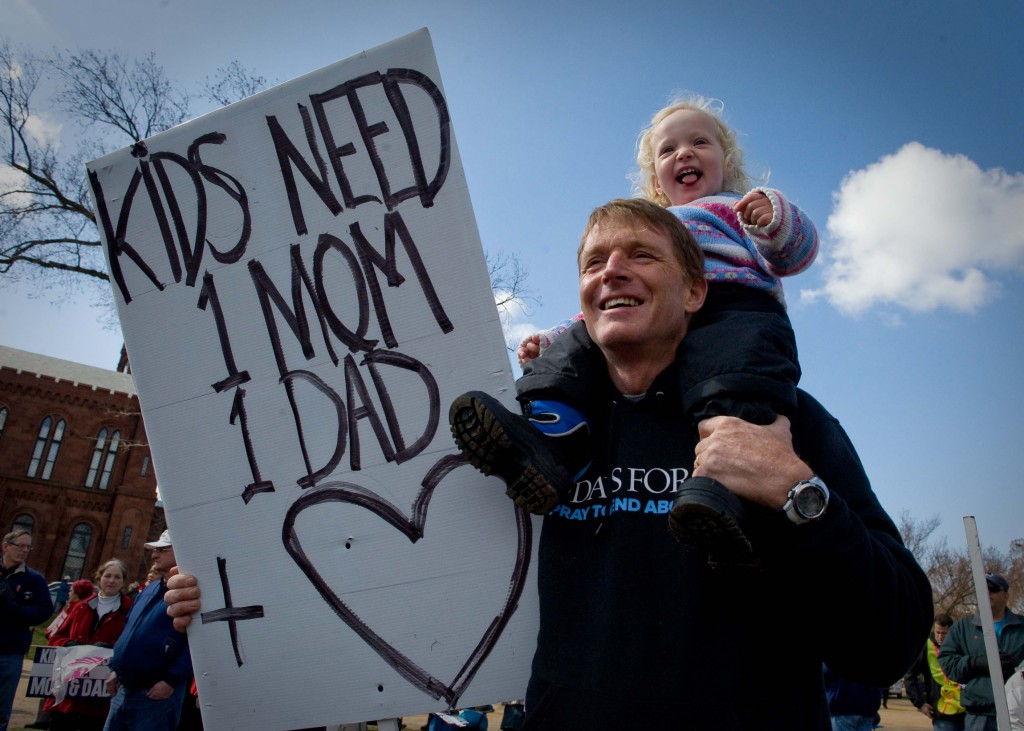 Robert Stone from Springfield, Mo., and his daughter, Miracle, attend the March for Marriage rally in Washington March 26. Thousands of people who gathered in support of traditional marriage took their message to the U.S. Supreme Court as they walked and held aloft placards objecting to same-sex marriage. PHOTO: CNS/Matthew Barrick