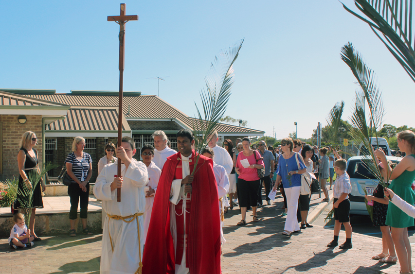 Rockingham assistant priest Fr George James leads parishioners into the Church of Our Lady of Lourdes to celebrate Palm Sunday. PHOTO: Leanne Joyce