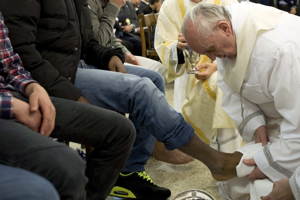 Pope Francis washes the foot of a prison inmate on March 28 during the Holy Thursday Mass of the Lord's Supper at Rome's Casal del Marmo prison for minors. Pope Francis washed the feet of 12 young people of different nationalities and faiths, including at least two Muslims and two women, who are housed at the juvenile detention facility. PHOTO: CNS/L'Osservatore Romano via Reuters