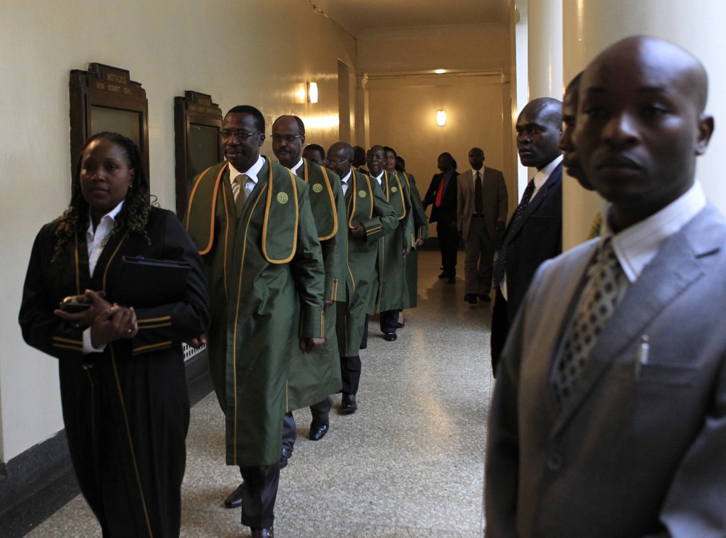 Supreme Court judges walk back after a break in the presidential poll petition hearings on March 28 in Kenya's capital, Nairobi. Cardinal John Njue of Nairobi is urging Kenyans to maintain peace as the court rules on the presidential election. PHOTO: CNS/Noor Khamis, Reuters