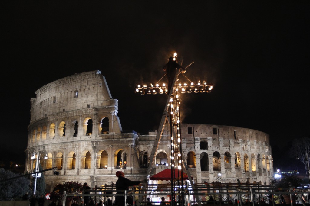 A worker lights torches on a cross outside Rome's ancient Colosseum on March 29 before Pope Francis leads his first Good Friday Way of the Cross as pope. PHOTO: CNS/Paul Haring