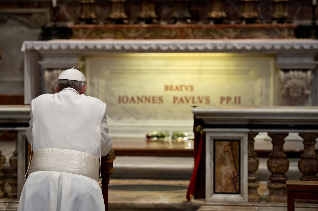 Pope Francis prays in front of the tomb of the late Blessed John Paul II in St. Peter's Basilica at the Vatican April 2, the eighth anniversary of his death. PHOTO: CNS/L'Osservatore Romano via Reuters