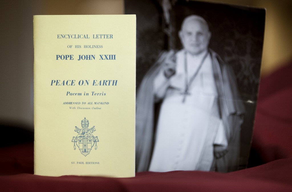An early edition of the encyclical "Peace on Earth" ("Pacem in Terris") is pictured next to a photo of its author, Pope John XXIII. The landmark papal letter addressing universal human rights and relations between states on April 11 marks its 50th anniversary. PHOTO: CNS/Nancy Phelan Wiechec 