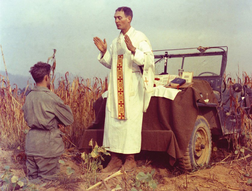 U.S. Army chaplain Father Emil Joseph Kapaun, who died May 23, 1951, in a North Korean prisoner of war camp, is pictured celebrating Mass from the hood of a jeep Oct. 7, 1950, in South Korea. PHOTO: CNS/courtesy U.S. Army medic Raymond Skeehan.