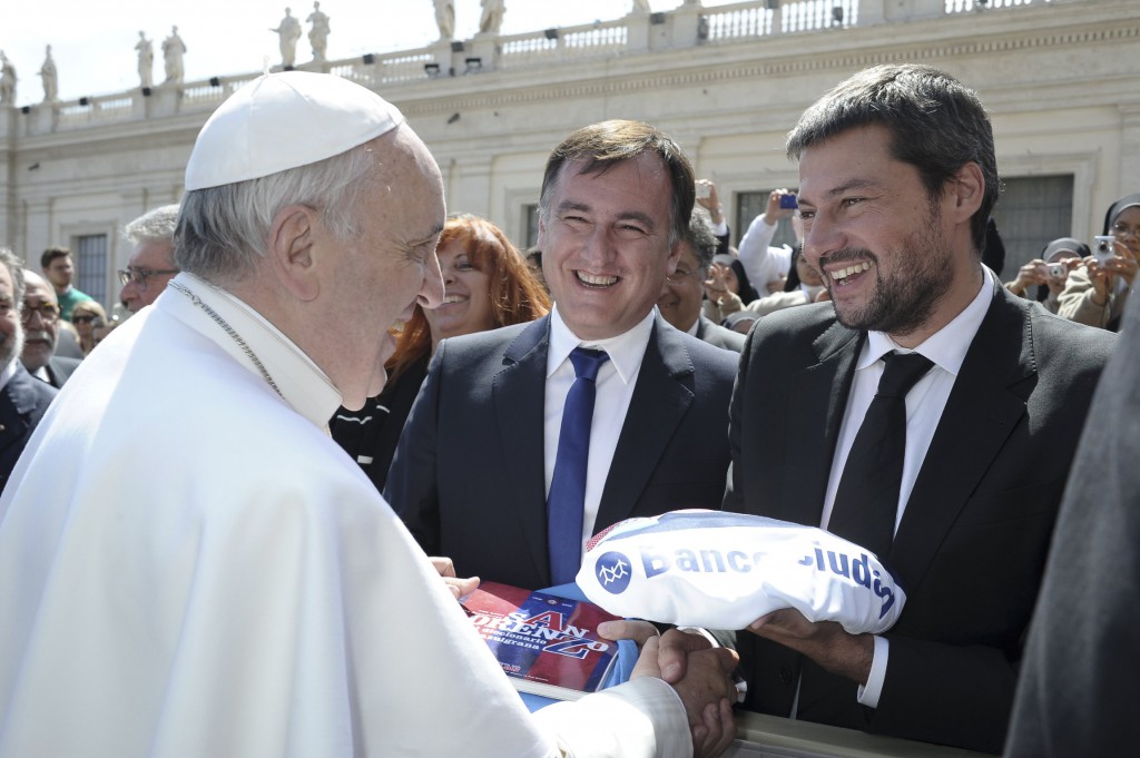 Pope Francis is presented with a gift on April 10 from Matias Lammens, president of Club Atletico San Lorenzo soccer, during the pope's weekly audience in St. Peter's Square at the Vatican. PHOTO: CNS/L'Ossevatore Romano via Reuters