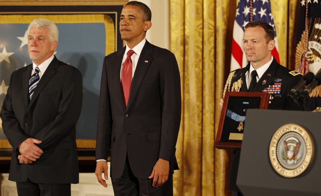 U.S. President Barack Obama stands next to Ray Kapaun, left, nephew of U.S. Army chaplain Father Emil Joseph Kapaun, during the Medal of Honor ceremony on April 11 at the White House in Washington. PHOTO: CNS/Bob Roller