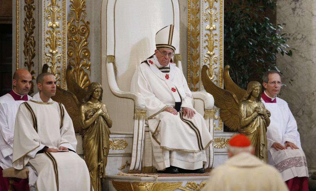 Pope Francis listens as he is addressed by U.S. Cardinal James M. Harvey, foreground, archpriest of the Basilica of St. Paul Outside the Walls, during Mass on April 14 at the basilica in Rome. PHOTO: CNS/Paul Haring
