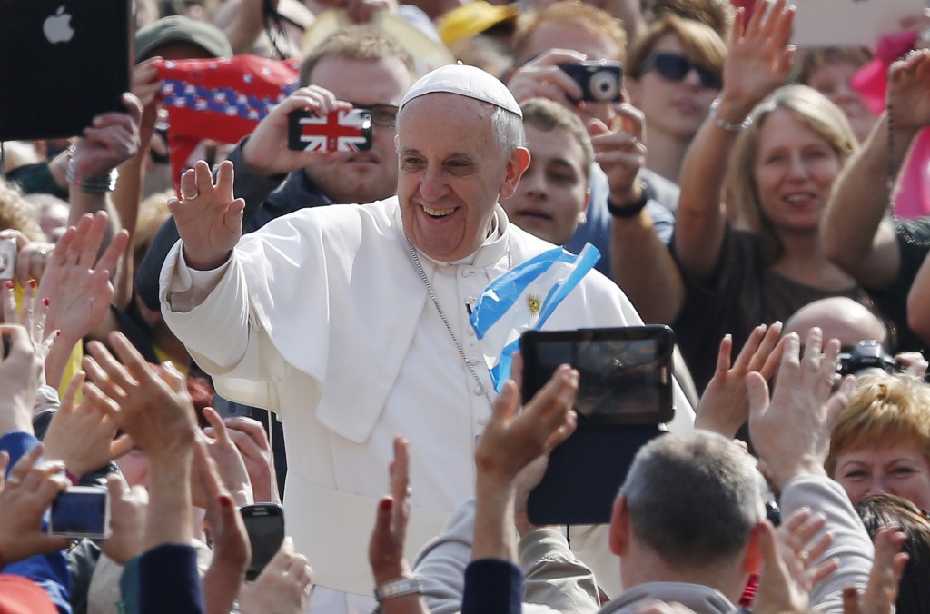 Pope Francis greets the crowd as he arrives to lead his general audience in St. Peter's Square at the Vatican April 17. PHOTO: CNS/Paul Haring