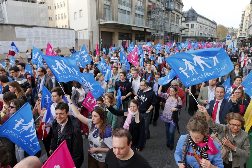 People wave banners as they demonstrate on April 17 against France's planned legalization of same-sex marriage in Paris. PHOTO: CNS/Benoit Tessier, Reuters People wave banners as they demonstrate on April 17 against France's planned legalization of same-sex marriage in Paris. PHOTO: CNS/Benoit Tessier, Reuters