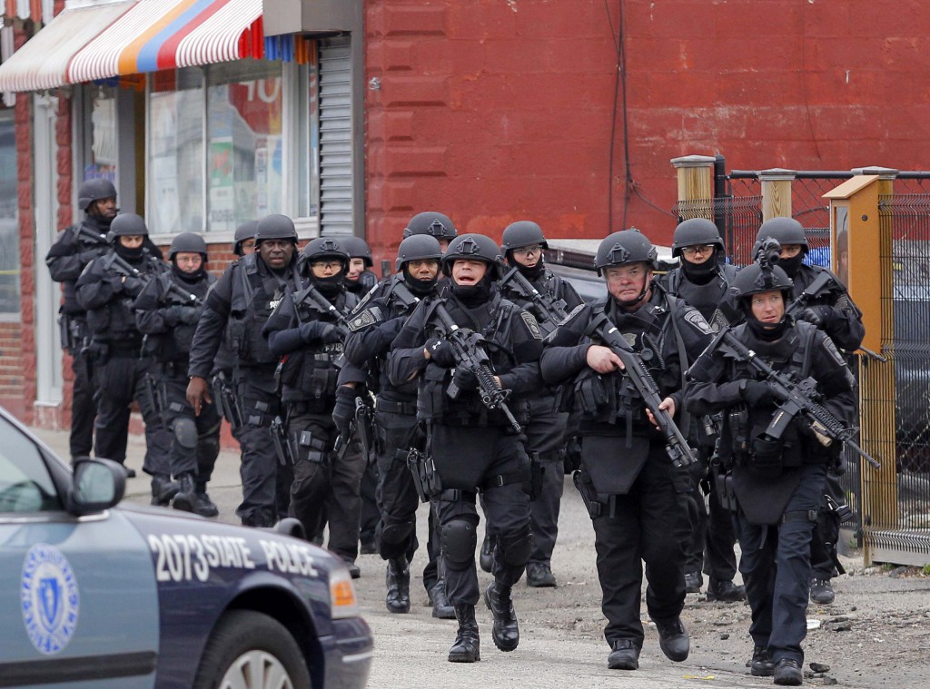 SWAT teams enter a neighborhood  in Watertown, Mass., April 19 to search an apartment for the remaining suspect in the Boston Marathon bombings following the shooting of a police officer at the Massachusetts Institute of Technology. PHOTO: CNS/Jessica Rinaldi, Reuters