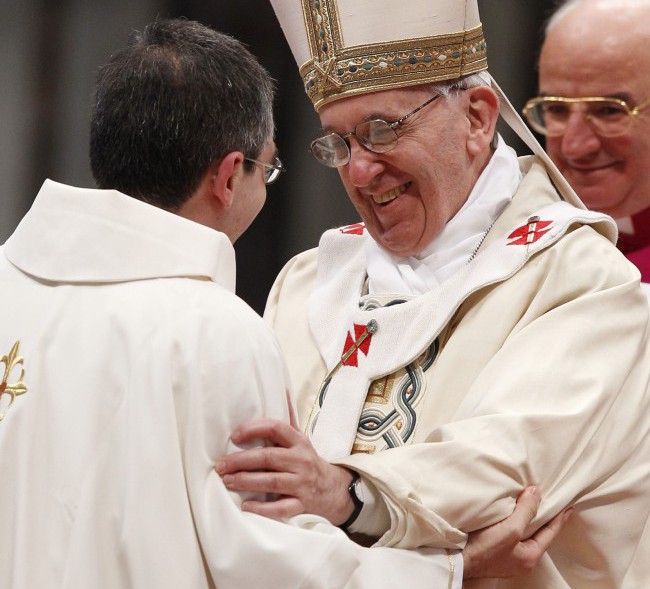 Pope Francis embraces one of the 10 priests he ordained on April 21 in St. Peter's Basilica at the Vatican. PHOTO: CNS/Paul Haring