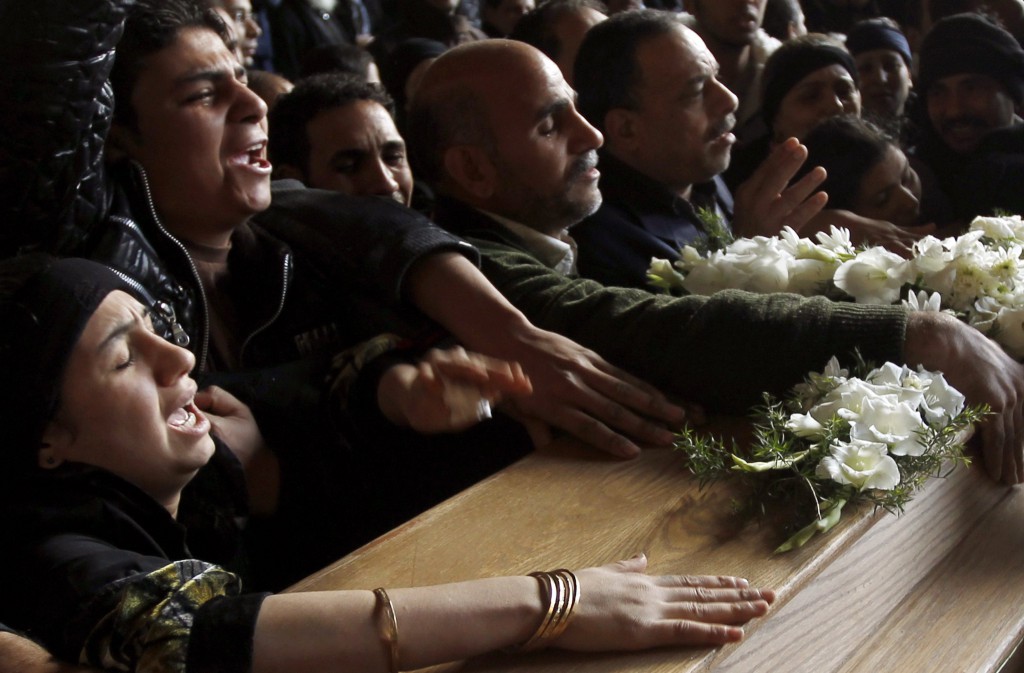 Coptic Christians grieve during the funeral for seven victims of sectarian violence at Samaan el-Kharaz Church in Cairo, Egypt, March 10. Thirteen people died and 140 were wounded in the clashes touched off by anger among Copts over an arson attack on a church the week before. PHOTO: CNS/Amr Abdallah Dalsh, Reuters