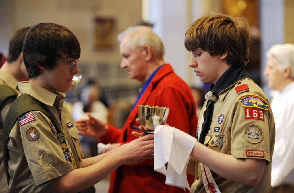 Boy Scouts serve as extraordinary ministers of holy Communion during a Catholic Scouting recognition Mass in 2010 at Sacred Heart Cathedral in Rochester, N.Y. The Boy Scouts of America voted May 23 to lift a ban on accepting openly gay Scouts as members, capping weeks of intense lobbying on both sides of the issue, the group said in a statement. PHOTO: CNS/Mike Crupi, Catholic Courier
