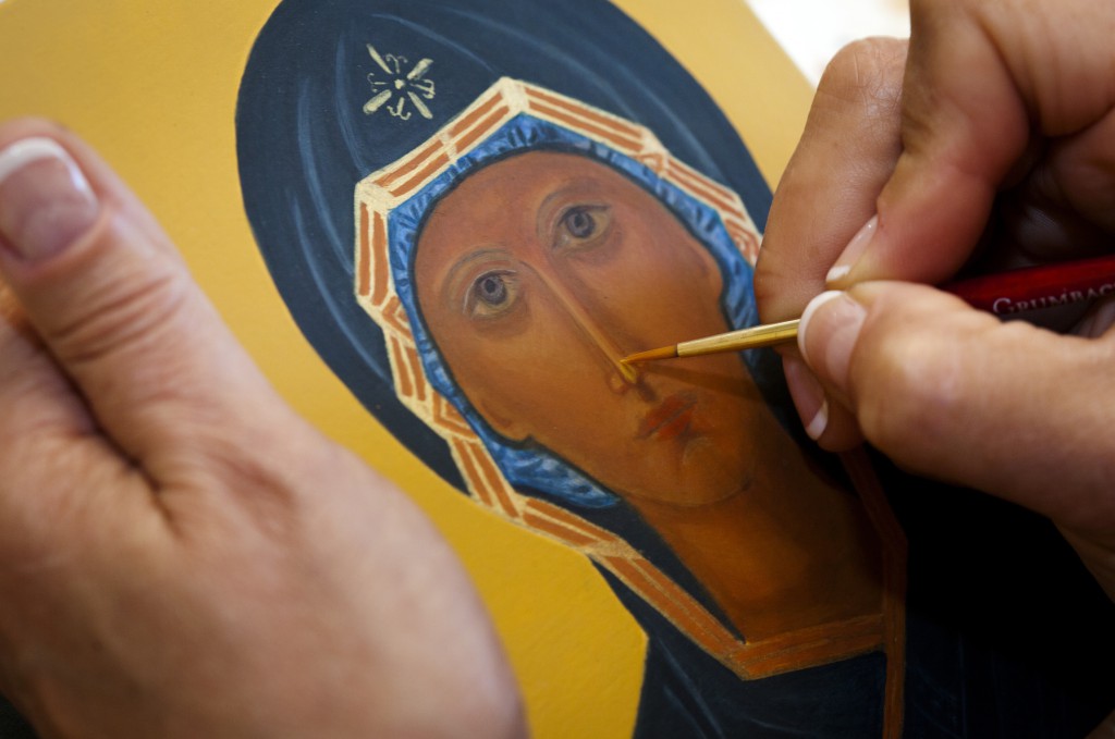 Teresa Foley paints detail on her icon of the Mother of God of the Sign May 25 at the home of iconographer Veronica Royal in Annandale, Va. Royal teaches iconography at her parish and home, promoting an ancient craft and infusing students with a sense of sacred art. PHOTO: CNS/Nancy Phelan Wiechec