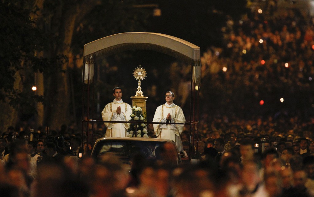 The annual Corpus Christi procession makes its way down a street in Rome May 30. Pope Francis walked in the candlelight procession accompanying the Blessed Sacrament from the Basilica of St. John Lateran to the Basilica of St. Mary Major. PHOTO: CNS/Paul Haring