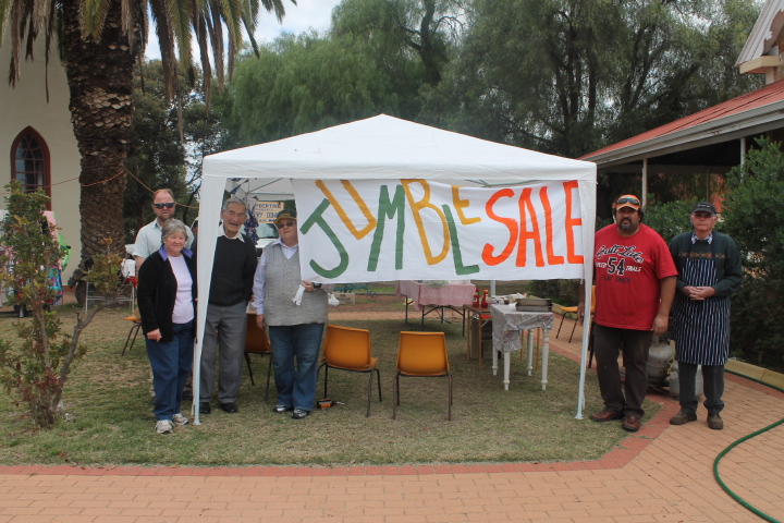From left, John Wrightson, Grace, Fr Steve, Josie Prunster, Mark Rehua and Fred stand beside the marquee they erected for the Jumble Sale.