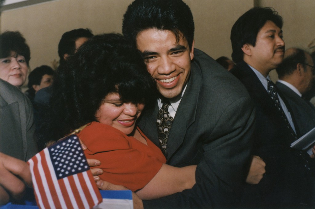 Two Guatemalan immigrants embrace after becoming U.S. citizens in 1996 during a naturalization ceremony held at a Catholic church in Hyattsville, Md. Catholic Legal Immigration Network Inc., known as CLINIC, was created 25 years ago to support Catholic agencies helping millions of people legalize their status following the 1986 passage of the Immigration Reform and Control Act. PHOTO: CNS/Michael Alexander