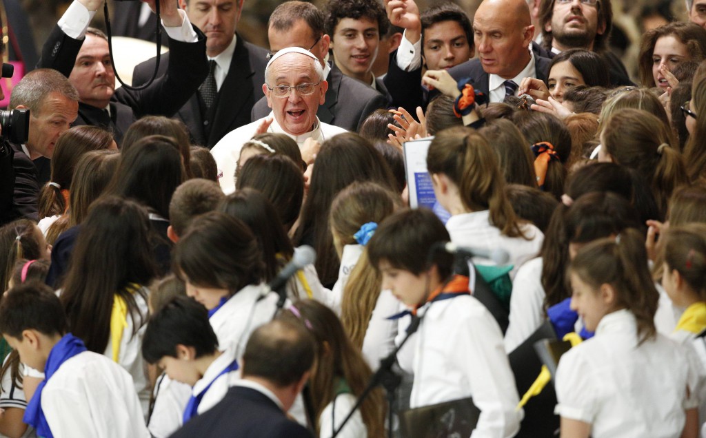 Youths surround Pope Francis as he meets with students from Jesuit schools June 7 in Paul VI hall at the Vatican. PHOTO: CNS/Max Rossi, Reuters