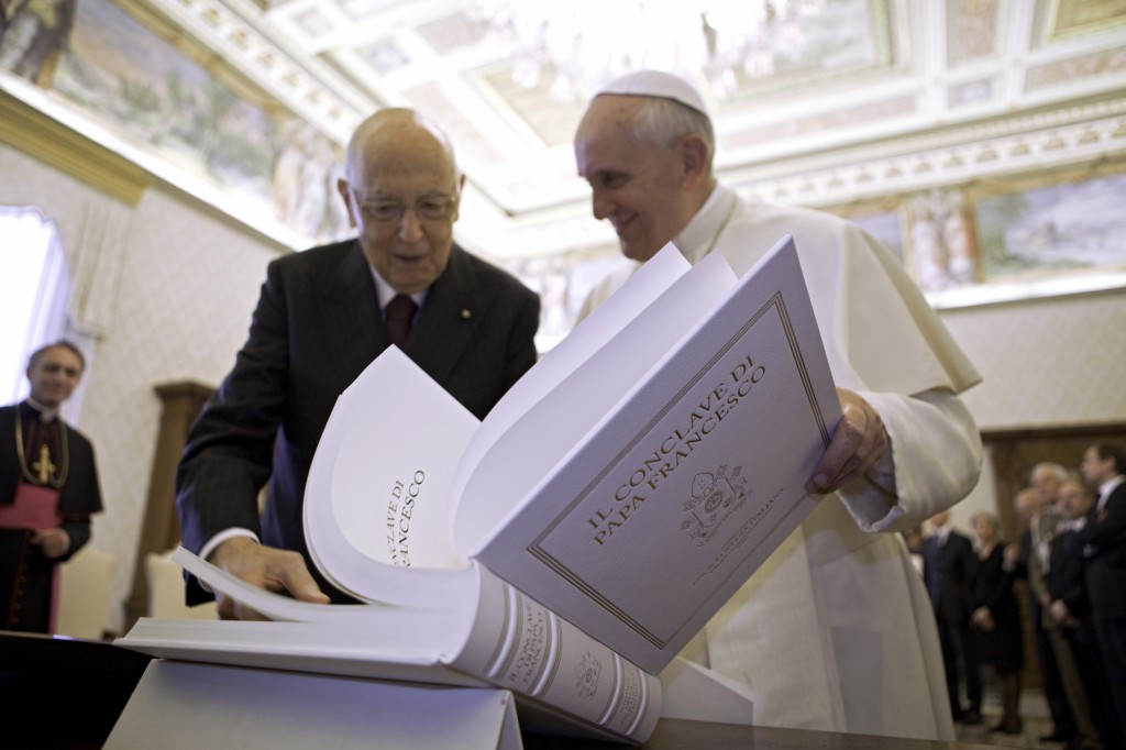 Pope Francis looks over a book with Italian President Giorgio Napolitano during a private meeting on June 8 at the Vatican. PHOTO: CNS/Maria Grazia Picciarella, pool 