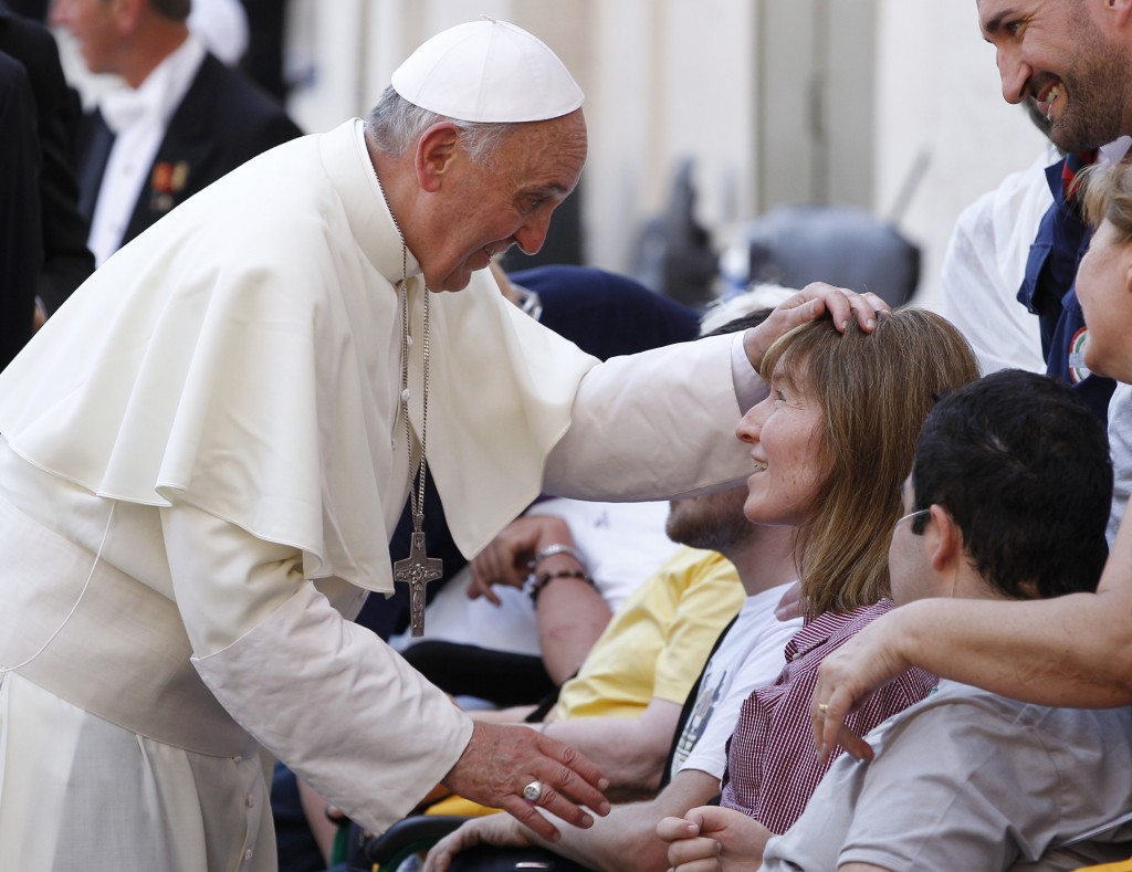 Pope Francis blesses a woman as he greets people who have disabilities following Mass in St. Peter's Square at the Vatican June 17. The Year of Faith Mass concluded a weekend of events calling attention to care for the aged, the sick, the unborn and those with disabilities. PHOTO: CNS/Paul Haring