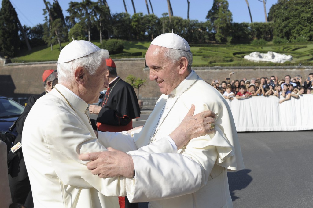 Pope Francis, right, embraces retired Pope Benedict XVI during a ceremony in the Vatican gardens July 5. During the service,  Pope Francis blessed a new statue of St. Michael the Archangel and recited separate prayers to consecrate Vatican City to St. Joseph and to St. Michael. PHOTO: CNS/L'Osservatore Romano via Reuters