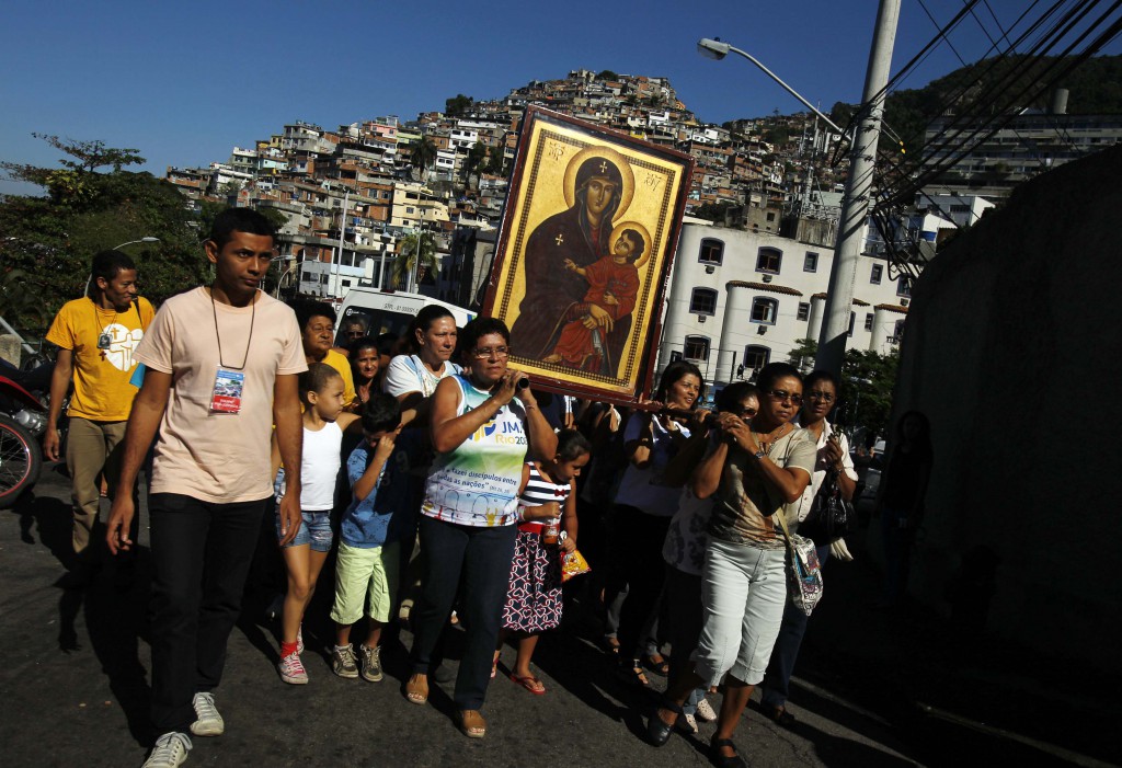 The World Youth Day icon of Mary is carried through the Vidigal slum in Rio de Janeiro July 15 as Brazilian Catholics gear up for the international event with Pope Francis. World Youth Day officials in Rio said that more 320,000 pilgrims from around the world had registered for the event. PHOTO: CNS/Ricardo Moraes, Reuters